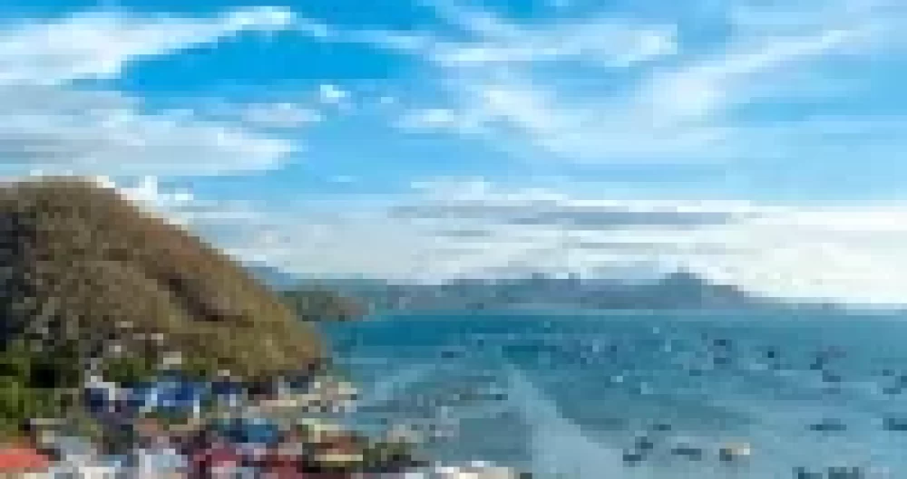 Panoramic view of Labuan Bajo town and harbor, home base for Komodo liveaboard diving adventures in the Coral Triangle
